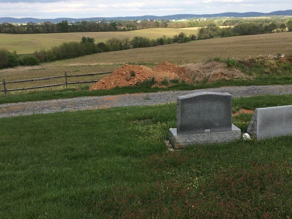 A deliberately framed pile of dirt at Burkittsville Cemetery referencing The Blair Witch Project